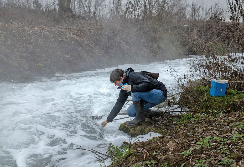 Researcher Sara Valsecchi collects wastewater from the Solvay plant in Spinetta Marengo in order to determine the concentration of PFAS. 2022. Courtesy of Elisabetta Zavoli.